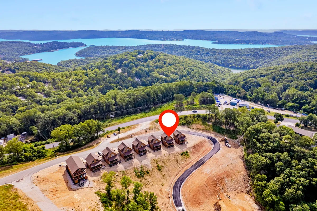 A cluster of cozy cabins nestled among lush greenery with a direct view of the lake. The landscape is tranquil, perfect for family gatherings, sunsets, or stargazing by the water.